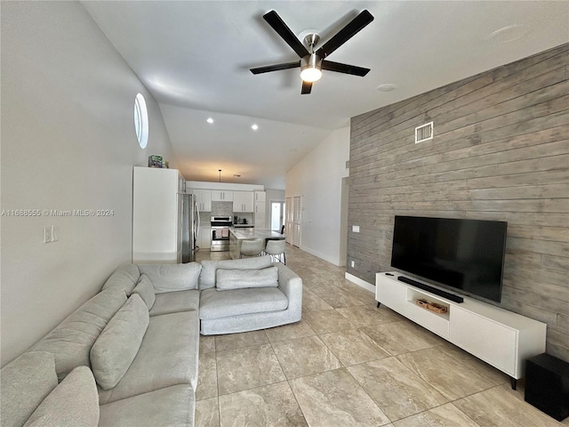 living room featuring ceiling fan and high vaulted ceiling