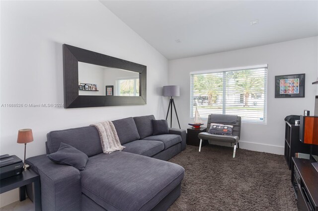 living room with vaulted ceiling and dark carpet