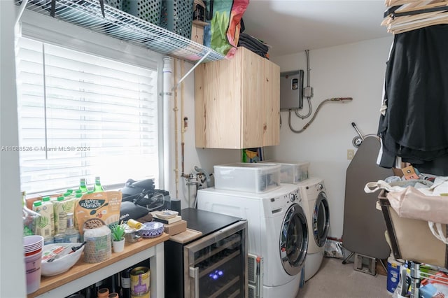 laundry area featuring light colored carpet, cabinets, and washing machine and clothes dryer