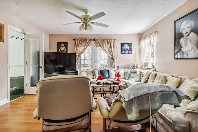 living room featuring ceiling fan and light wood-type flooring