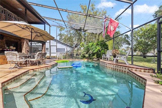 view of pool featuring glass enclosure and a patio