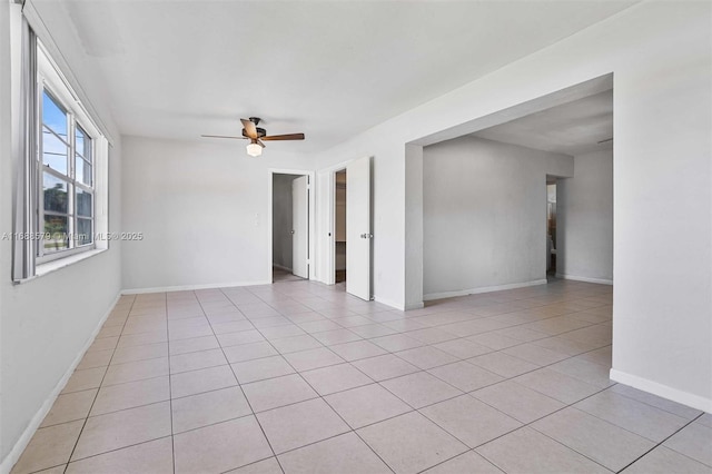 spare room featuring ceiling fan and light tile patterned floors