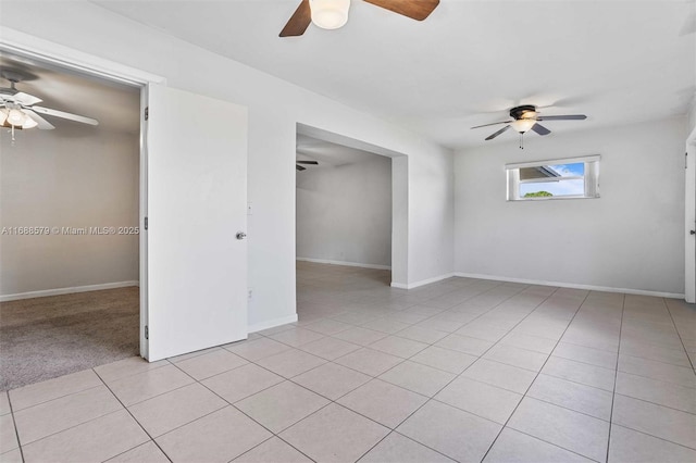 interior space with light tile patterned floors and ceiling fan