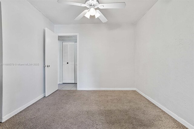 tiled empty room with ceiling fan