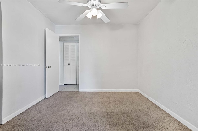 unfurnished room featuring ceiling fan and light carpet