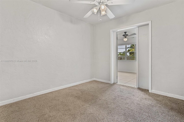 unfurnished room with carpet flooring and ceiling fan