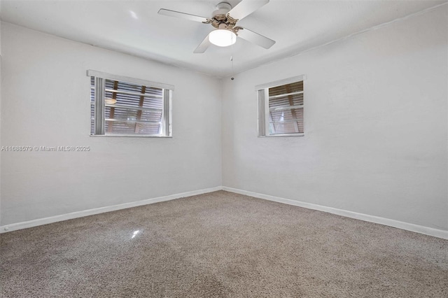 spare room featuring ceiling fan and a wealth of natural light