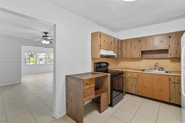 kitchen with black electric range oven, sink, backsplash, and light tile patterned floors