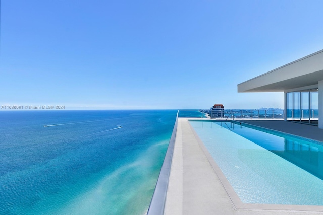 view of swimming pool with a water view