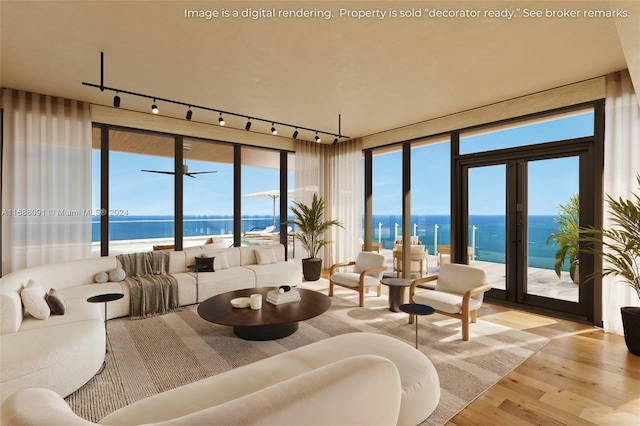 living room featuring a water view, track lighting, light hardwood / wood-style floors, and french doors