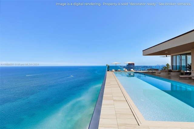 view of pool with a water view