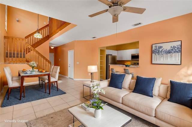 living room featuring ceiling fan and light tile patterned floors