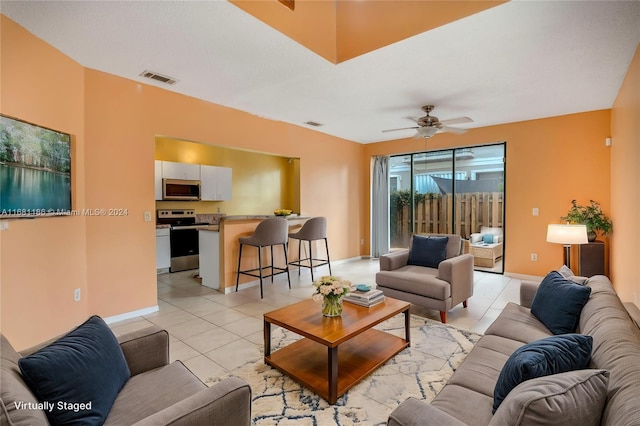 living room with ceiling fan and light tile patterned flooring