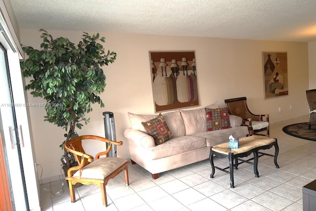 living room featuring a textured ceiling and light tile patterned floors