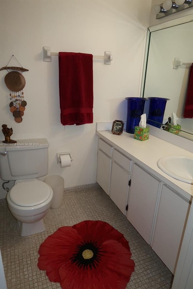 bathroom with tile patterned floors, vanity, and toilet