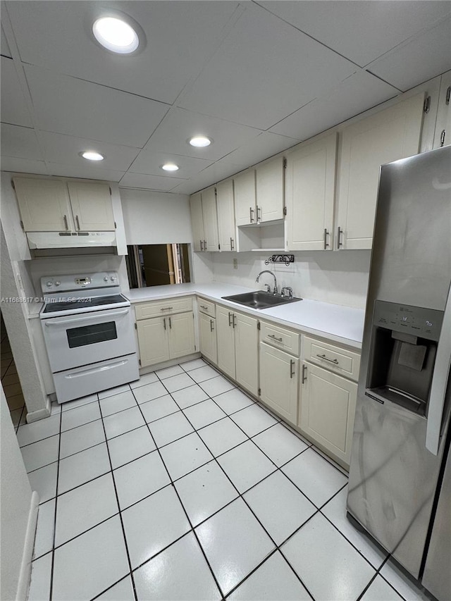 kitchen with light tile patterned floors, white electric range oven, stainless steel fridge with ice dispenser, and sink