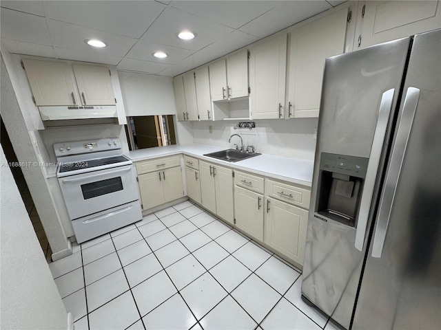 kitchen featuring stainless steel refrigerator with ice dispenser, white range with electric cooktop, sink, and light tile patterned flooring