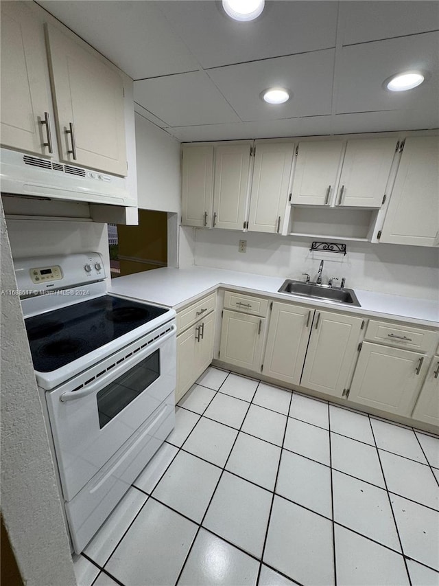 kitchen with light tile patterned floors, white electric stove, and sink