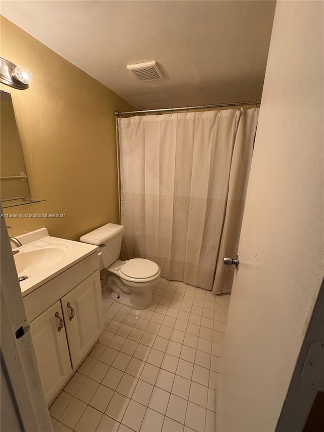 bathroom with vanity, tile patterned floors, toilet, and a shower with shower curtain