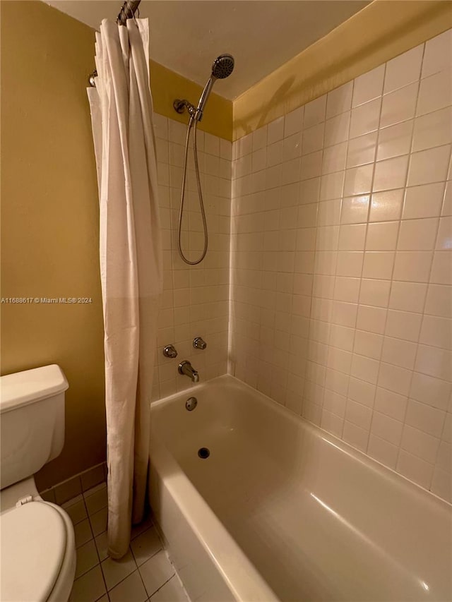 bathroom featuring shower / bath combo, tile patterned floors, and toilet