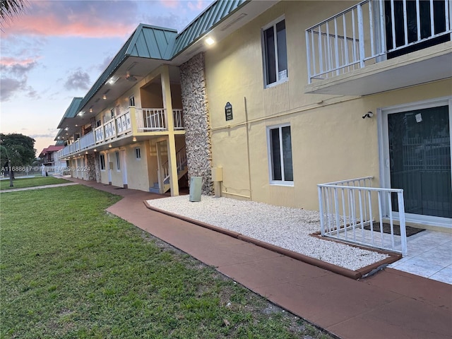 view of community featuring a yard and a patio area