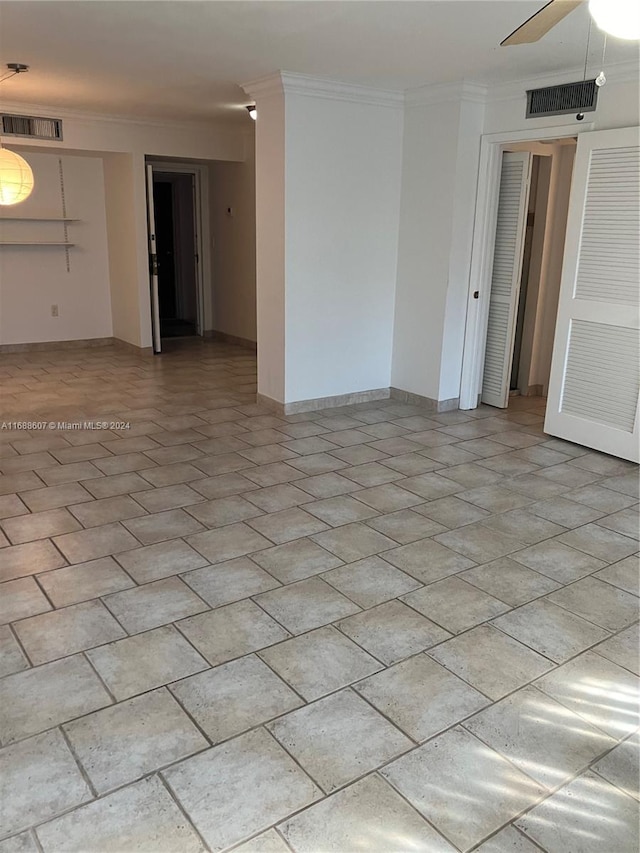 unfurnished room with ceiling fan and crown molding