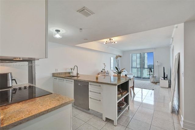 kitchen featuring black electric stovetop, light stone counters, stainless steel dishwasher, light tile patterned flooring, and white cabinetry