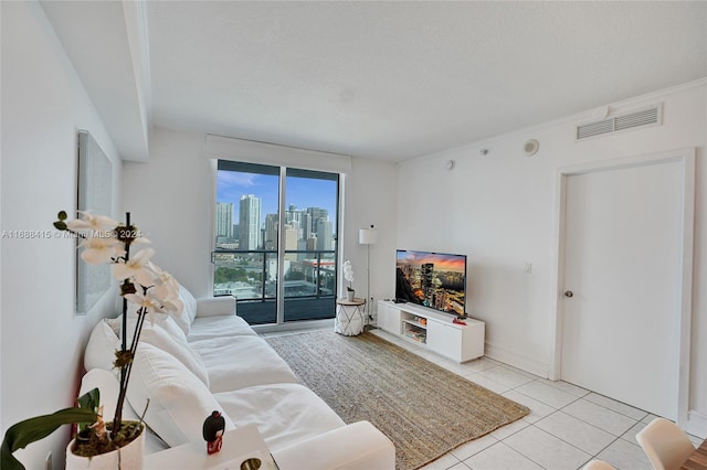 tiled living room featuring a textured ceiling