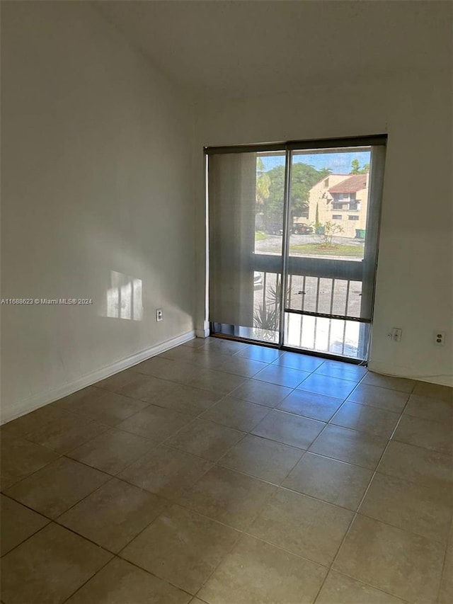 spare room with light tile patterned floors