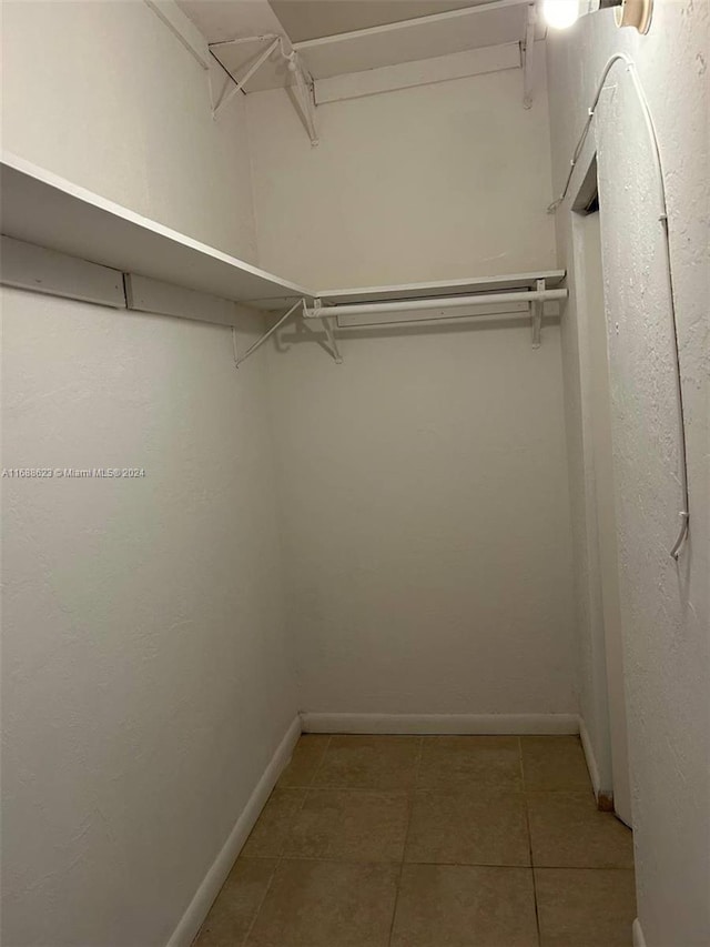 spacious closet with tile patterned floors