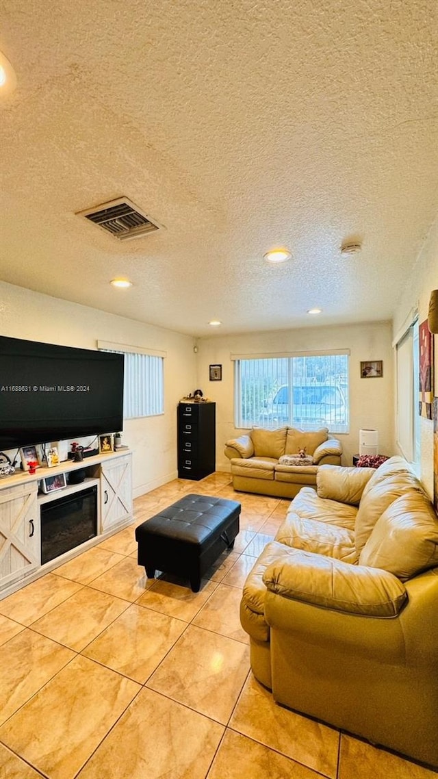 tiled living room with a textured ceiling