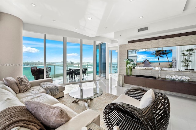 living room with a water view and light tile patterned floors