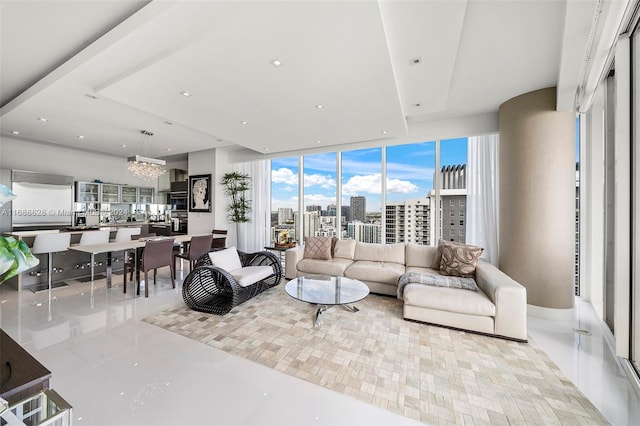 tiled living room with expansive windows and a chandelier