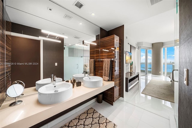 bathroom with vanity, a water view, and tile patterned floors