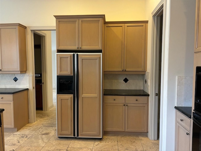 kitchen with oven, decorative backsplash, and paneled built in fridge