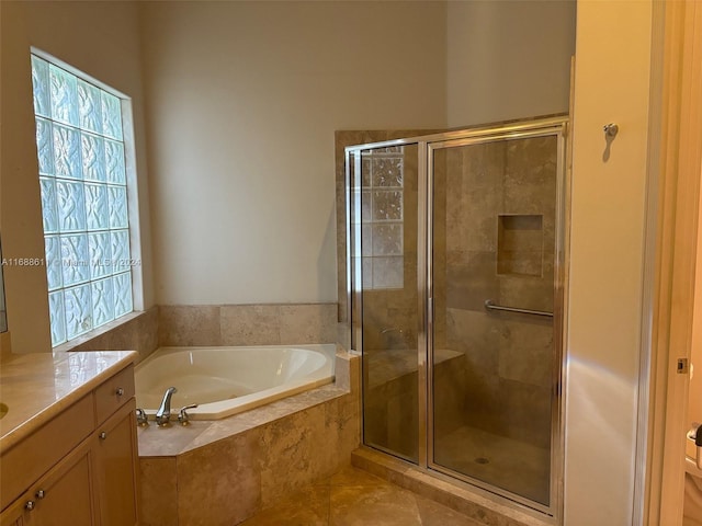 bathroom featuring vanity, tile patterned floors, and plus walk in shower