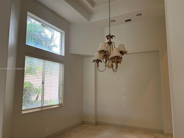 spare room with an inviting chandelier