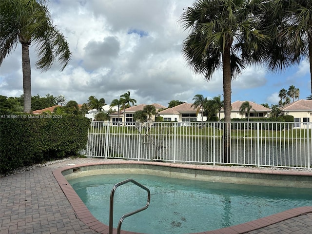 view of swimming pool featuring a water view