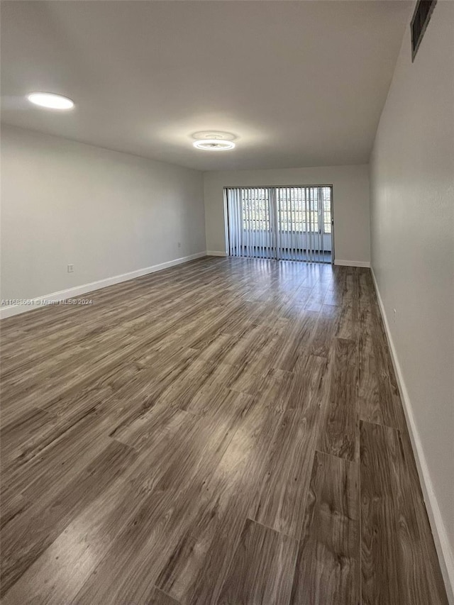 unfurnished room featuring dark hardwood / wood-style flooring