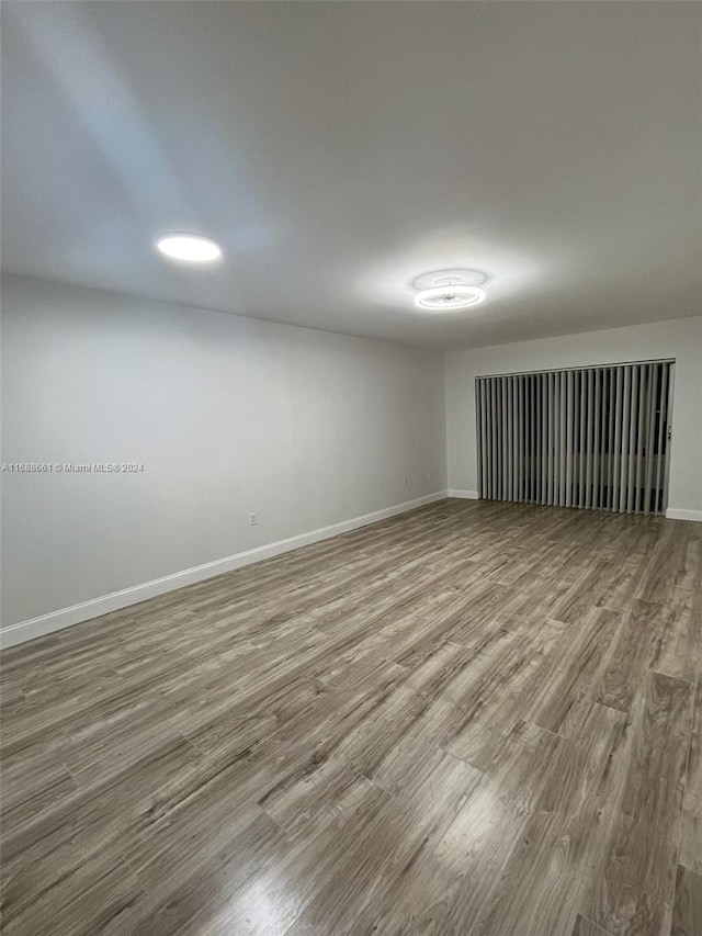 spare room with wood-type flooring