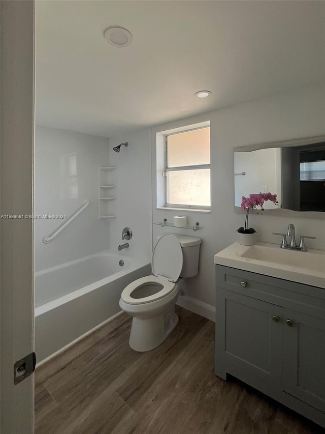 full bathroom with vanity, hardwood / wood-style flooring, tub / shower combination, and toilet