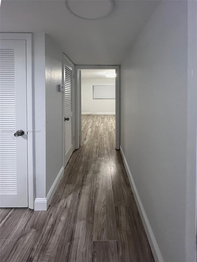 hall with dark hardwood / wood-style flooring