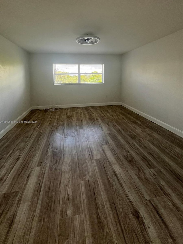 empty room with dark wood-type flooring