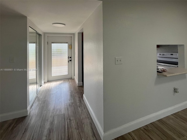 hallway with dark hardwood / wood-style flooring