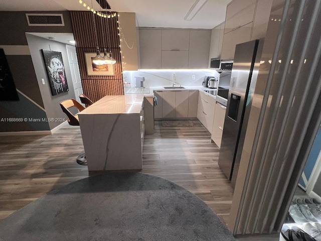 111 Golden Isles Dr Unit G5, Hallandale Beach, FL 33009 - kitchen with modern cabinets, dark wood-style flooring, light countertops, and gray cabinets