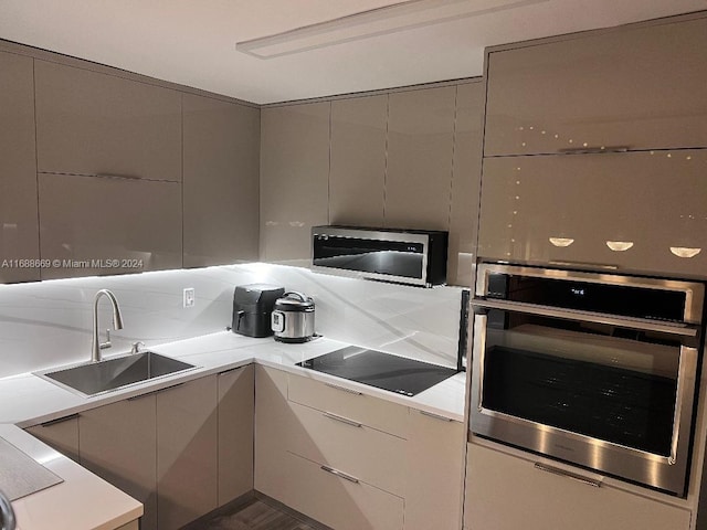 111 Golden Isles Dr Unit G5, Hallandale Beach, FL 33009 - kitchen with appliances with stainless steel finishes, gray cabinets, light countertops, and modern cabinets