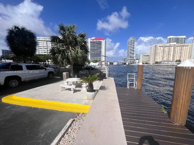 exterior space featuring a dock and a water view