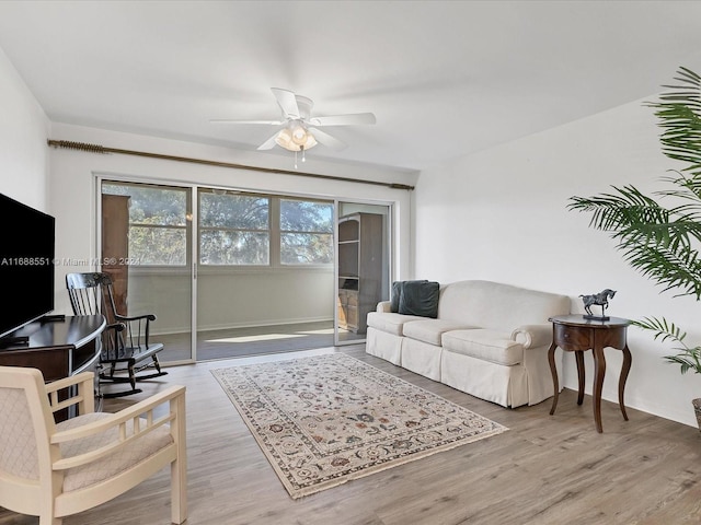 living room with hardwood / wood-style flooring and ceiling fan