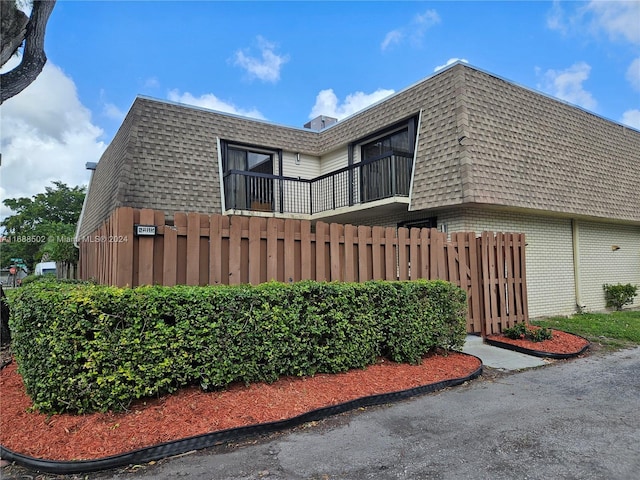 view of side of property with a balcony