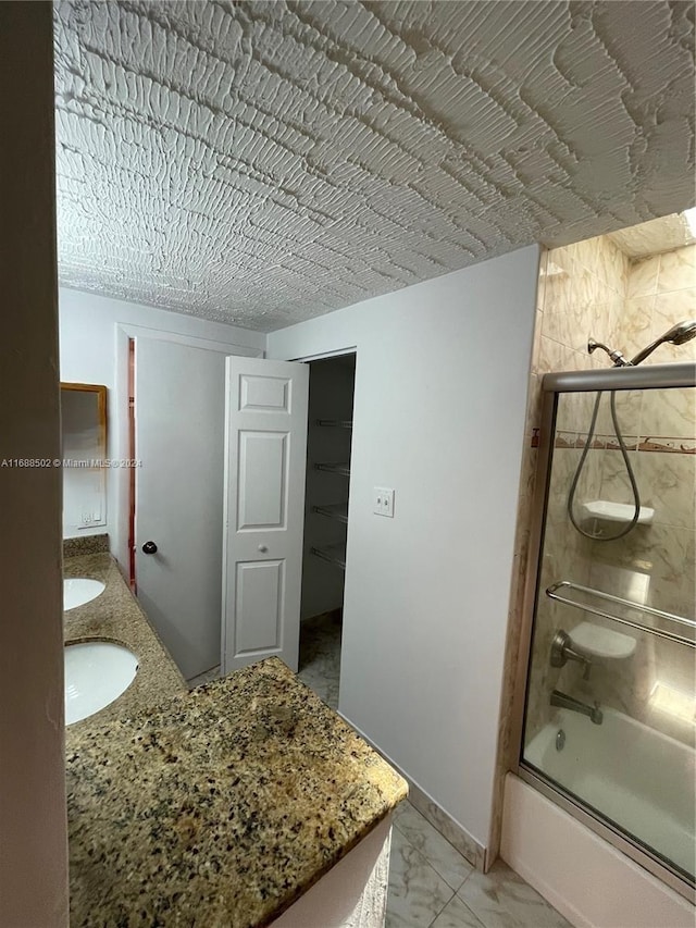 bathroom featuring vanity and enclosed tub / shower combo